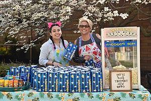 Deans giving out popcorn outside residence hall